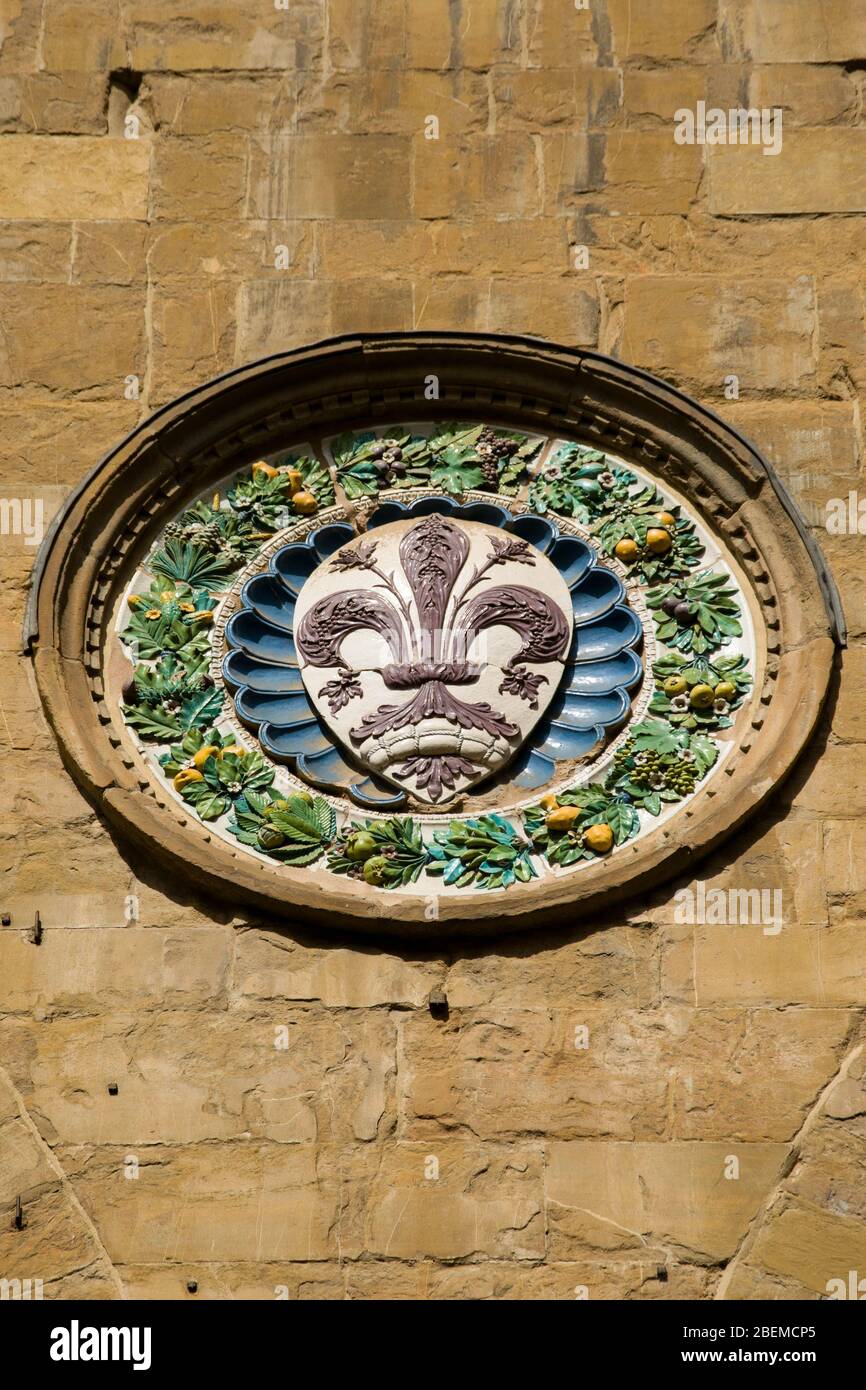 Flag of Florence, coat of arms, carved on the wall of historic building Stock Photo