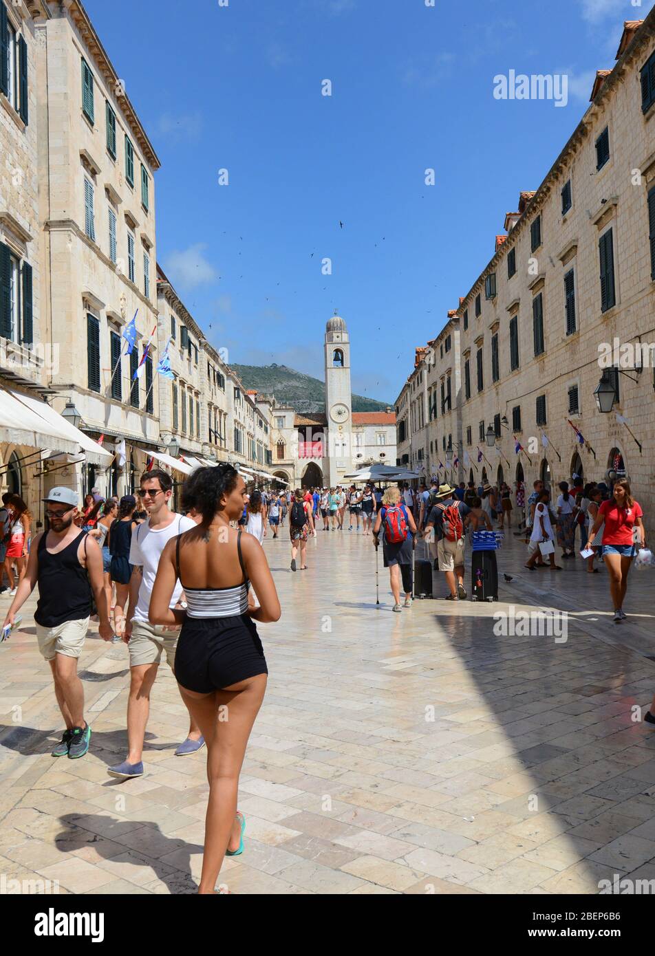 Tourist walking on the main street of the old town of Dubrovnik. Stock Photo