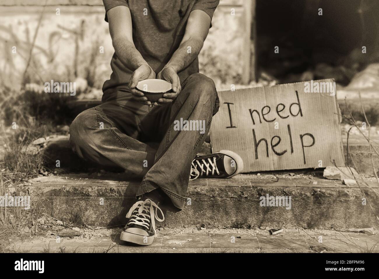 Poverty concept. Poor man begging for money on street Stock Photo