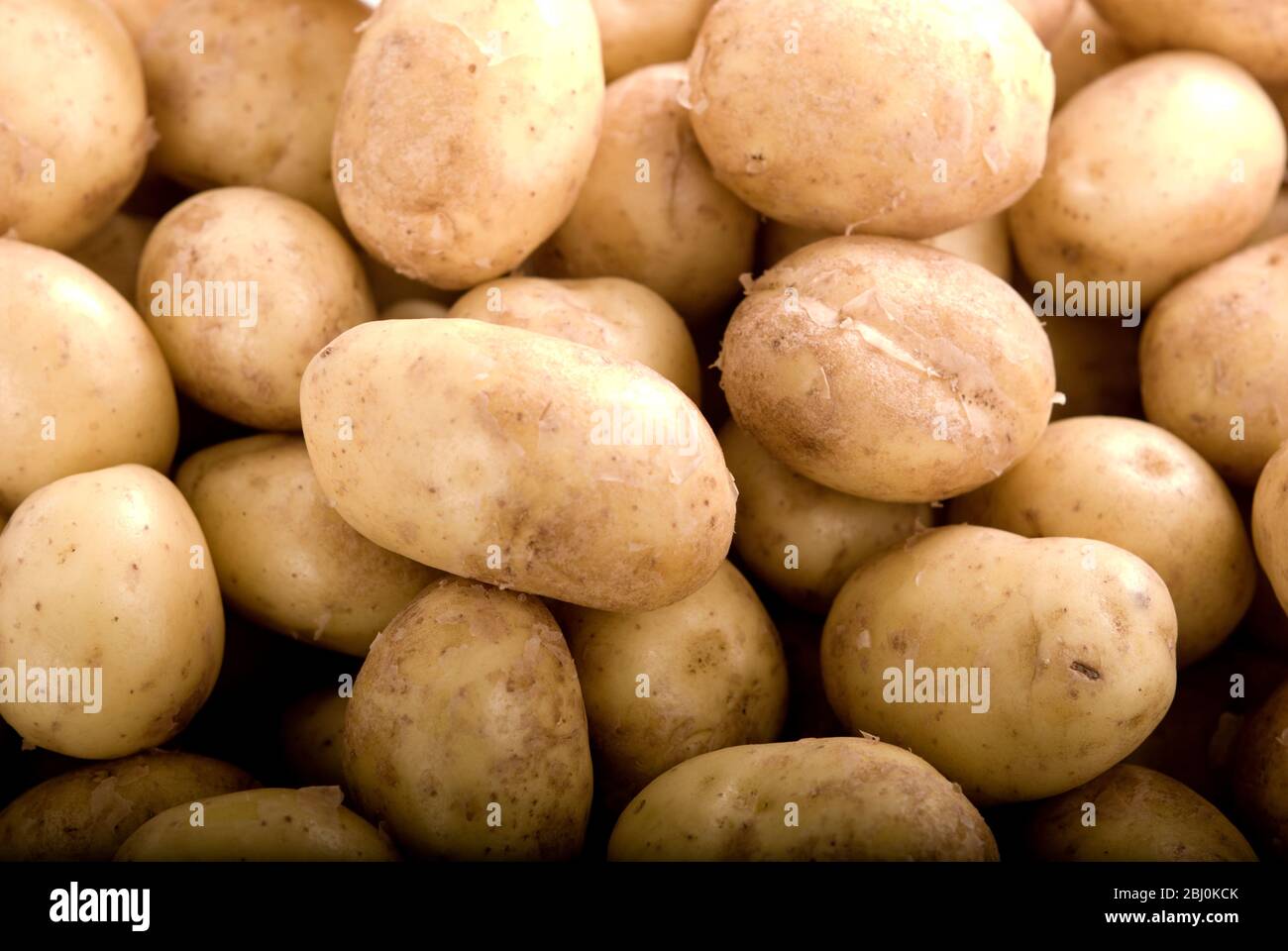 Small whole raw new potatoes. - Stock Photo