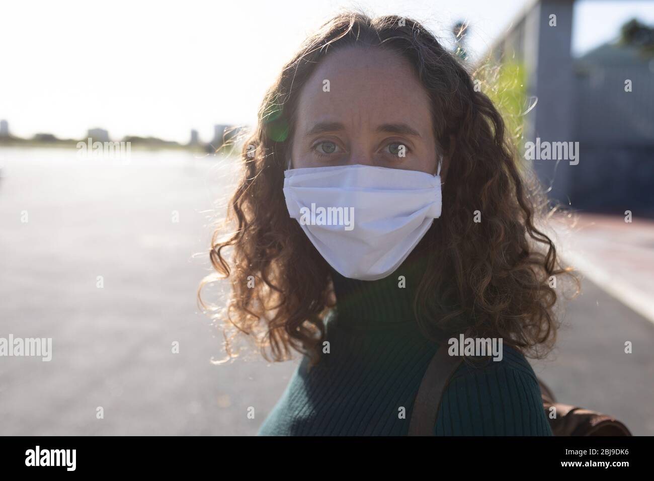 Caucasian woman wearing a protective mask and looking at the camera Stock Photo