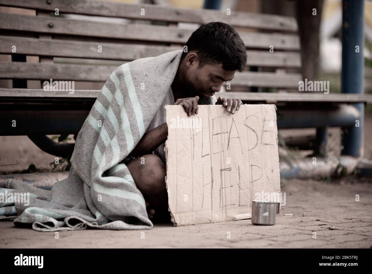 The poor man begs alms, homeless Asian man is begging for money Stock Photo