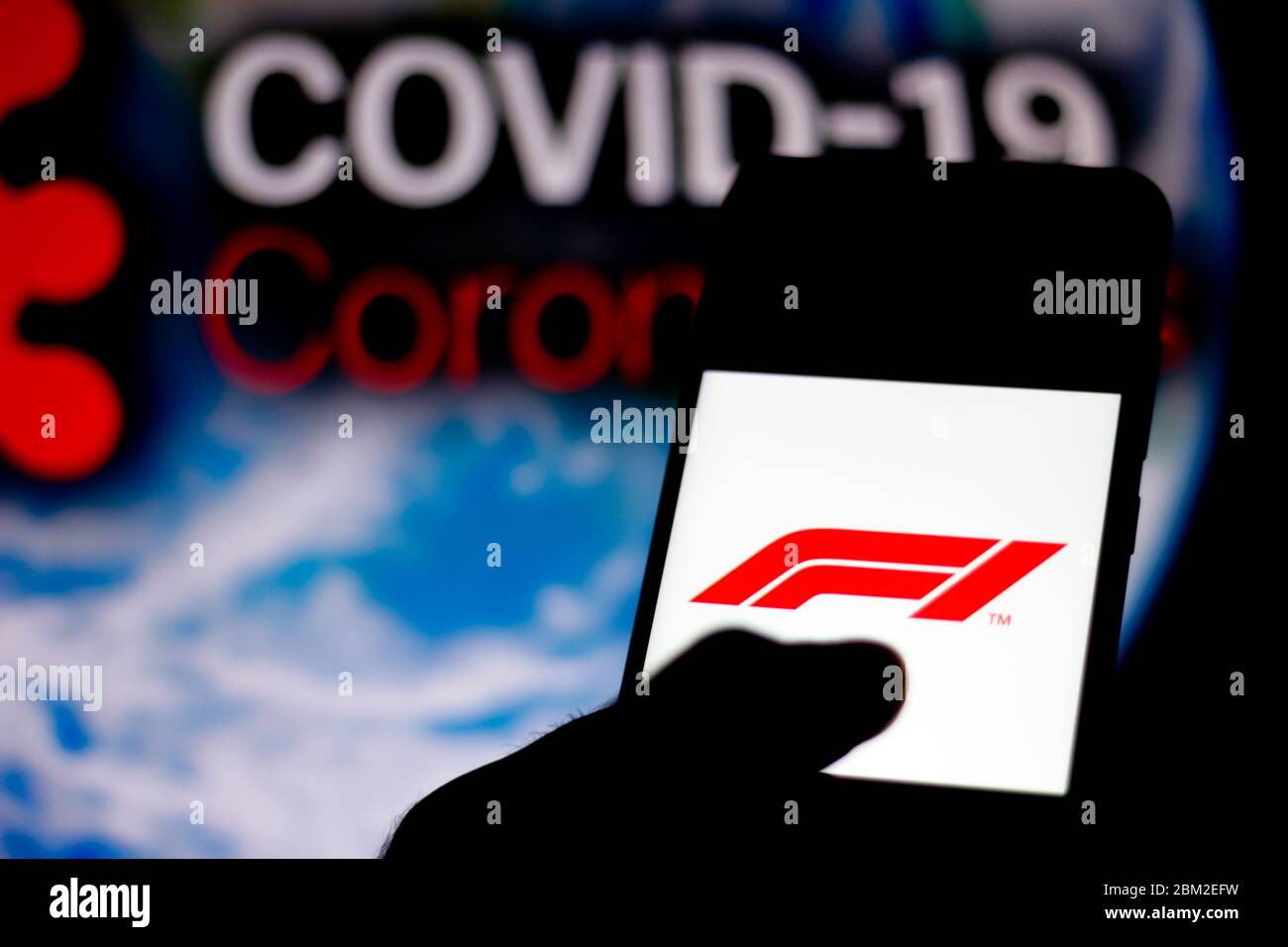 Brazil. 6th May, 2020. In this photo illustration the Formula One (F1) logo seen displayed on a smartphone with a computer model of the COVID-19 coronavirus in the background. Credit: Rafael Henrique/SOPA Images/ZUMA Wire/Alamy Live News Stock Photo