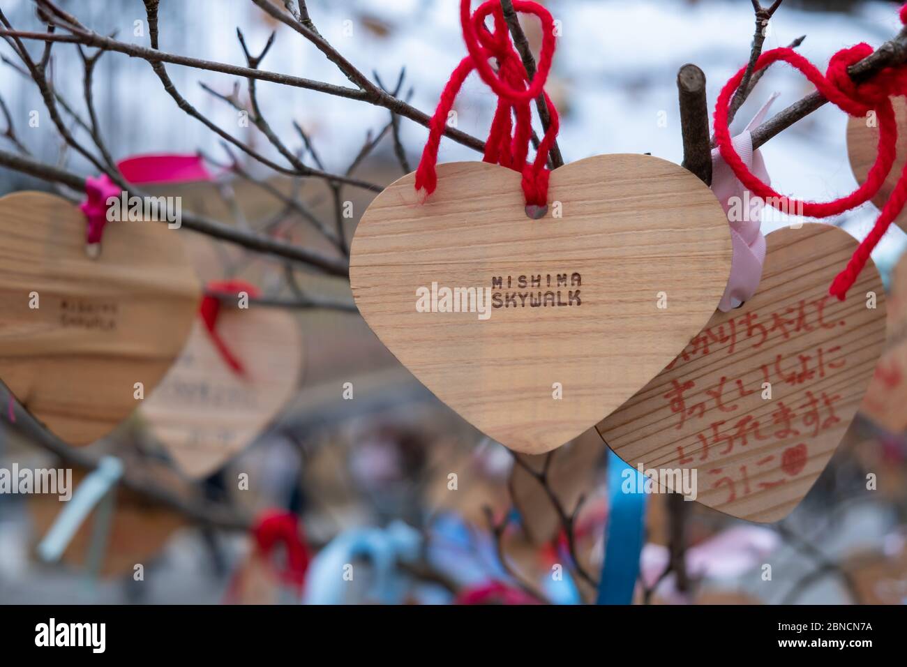 Shizuoka, Japan - March 23, 2019: View of the heart wooden tag of Mishima Skywalk hangs on the tree, a pedestrian bridge officially known as the Hakon Stock Photo