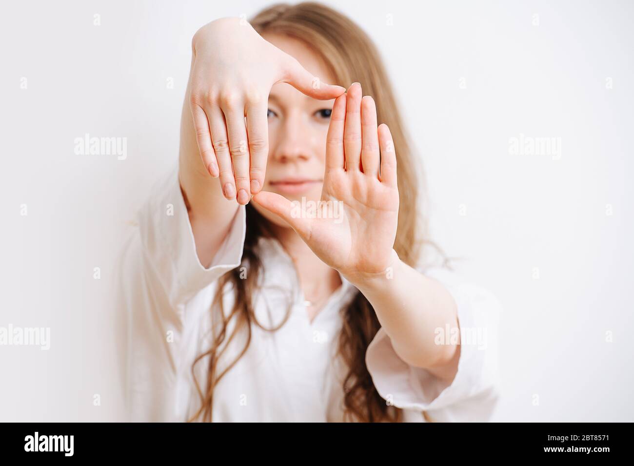 Girl stretching her arms forward, she making framing with her hands Stock Photo