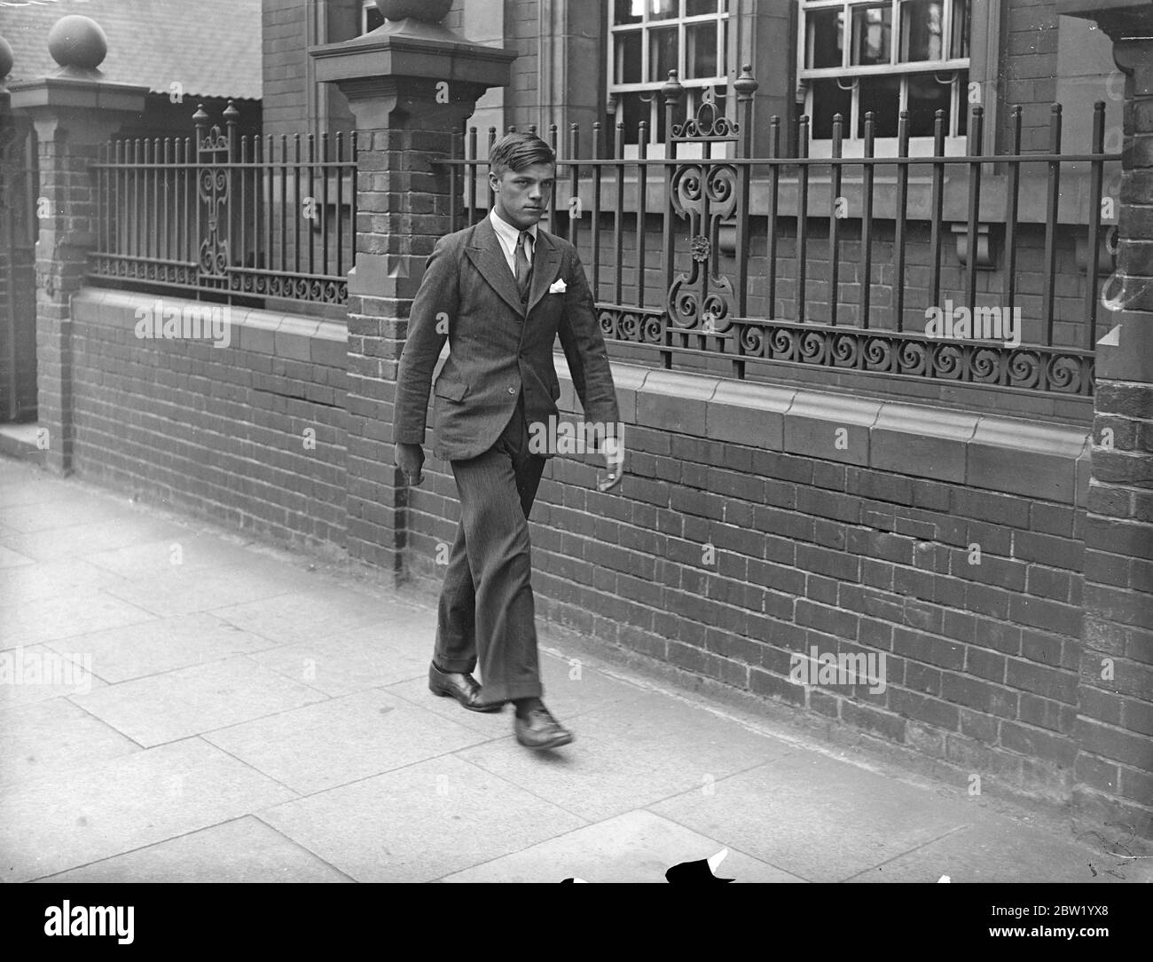 Man was arrested after the body of Daisy Vera Skeels, a 16-year-old waitress has been exhumed, for an inquest. Andrew Chumley was taken into custody on the coroners warrant on the charge of manslaughter. Photo shows: William Henry Skeels, brother of the dead girl, who accused Andrew Chumley, leaving after the inquest at Hounslow, London. 18 June 1937 Stock Photo