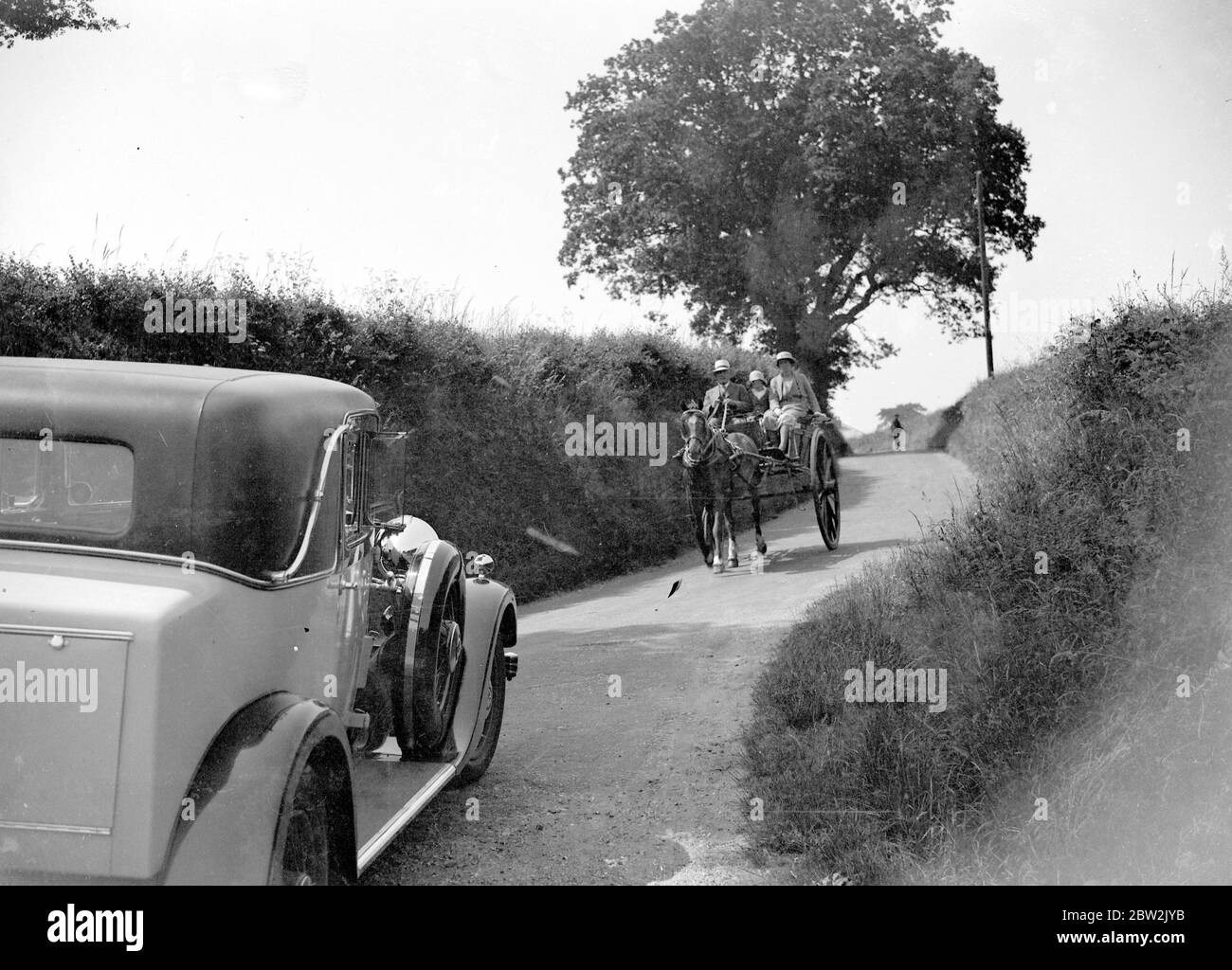 Car and a pony and trap. 1934 Stock Photo