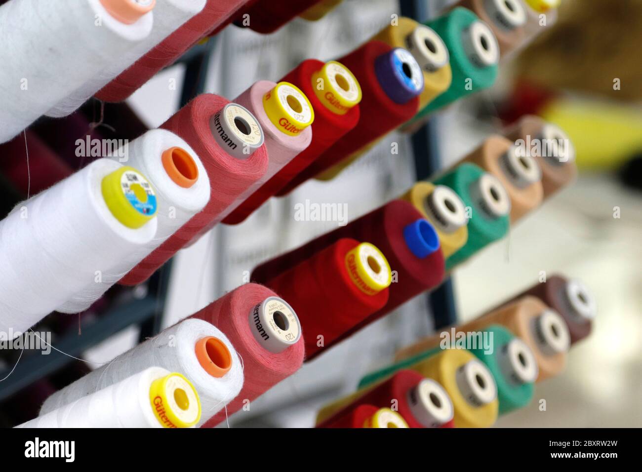 assortment of coloured reels of thread in a high fashion atelier in Italy Stock Photo