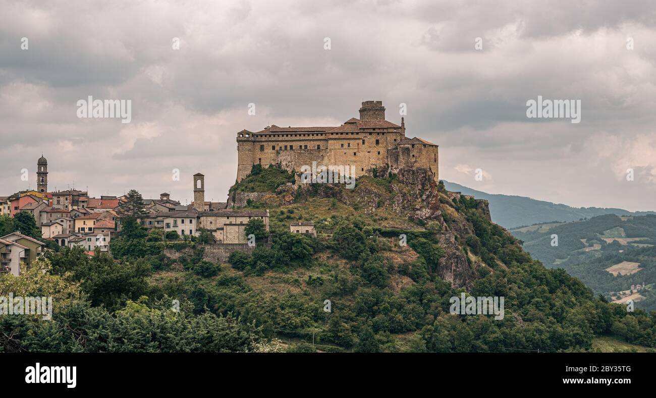 The castle and the village of Bardi in a cloudy day. Parma province, Emilia and Romagna, Italy. Stock Photo