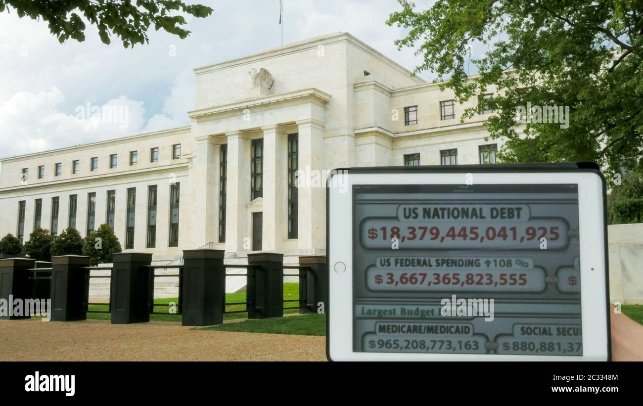 a debt clock and the exterior of the federal reserve building Stock Photo