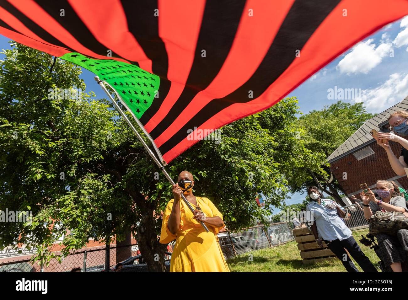 June 19, 2020, Boston, Massachusetts, USA: U.S. Rep. Ayanna Pressley (D-MA) poses a photo with a stylized American Black Lives Matter flag during a Juneteenth rally in Boston. Juneteenth commemorates when the last enslaved African Americans learned in 1865 they were free, more than two years following the Emancipation. Credit: Keiko Hiromi/AFLO/Alamy Live News Stock Photo