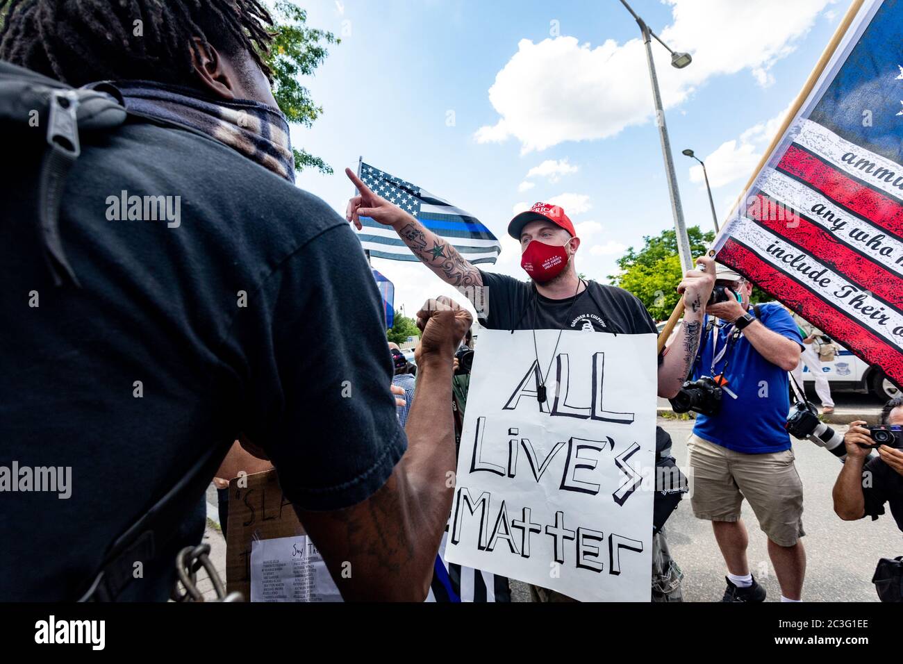 June 19, 2020, Boston, Massachusetts, USA: A man wearing a sign 'All lives matter' with a Three Per Cent Militia flag and Trump hat, argues with people who attend a Juneteenth rally in Boston. Juneteenth commemorates when the last enslaved African Americans learned in 1865 they were free, more than two years following the Emancipation Proclamation. Credit: Keiko Hiromi/AFLO/Alamy Live News Stock Photo