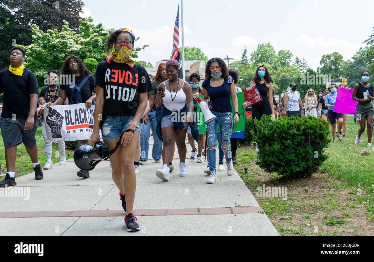 Black Lives Matter Protest Juneteenth March George Floyd - Protesters marching in front of American Flag in Teaneck NJ Stock Photo