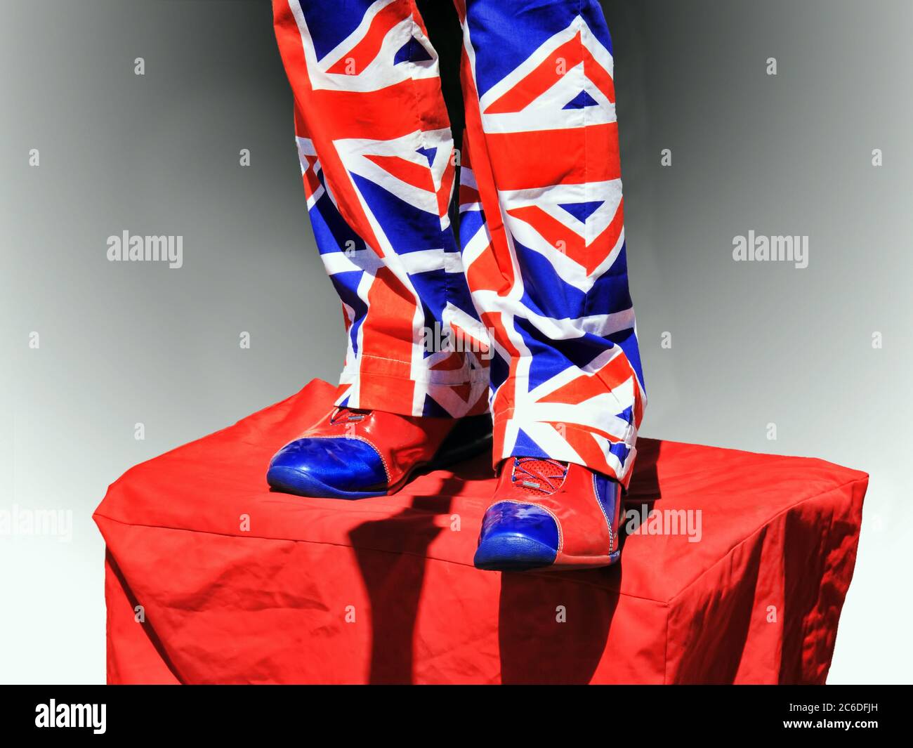 Street performer wearing trousers and shoes of the Union Jack flag of the UK in London England Stock Photo