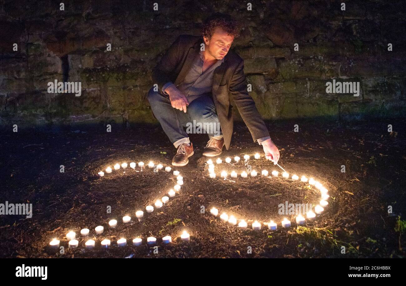 BAFTA award-winning film director Samir Mehanovic, who came to the UK as an immigrant from the Bosnian war in 1995 and now lives in Edinburgh, lights candles to commemorate the 25th anniversary of the Srebrenica genocide. Stock Photo