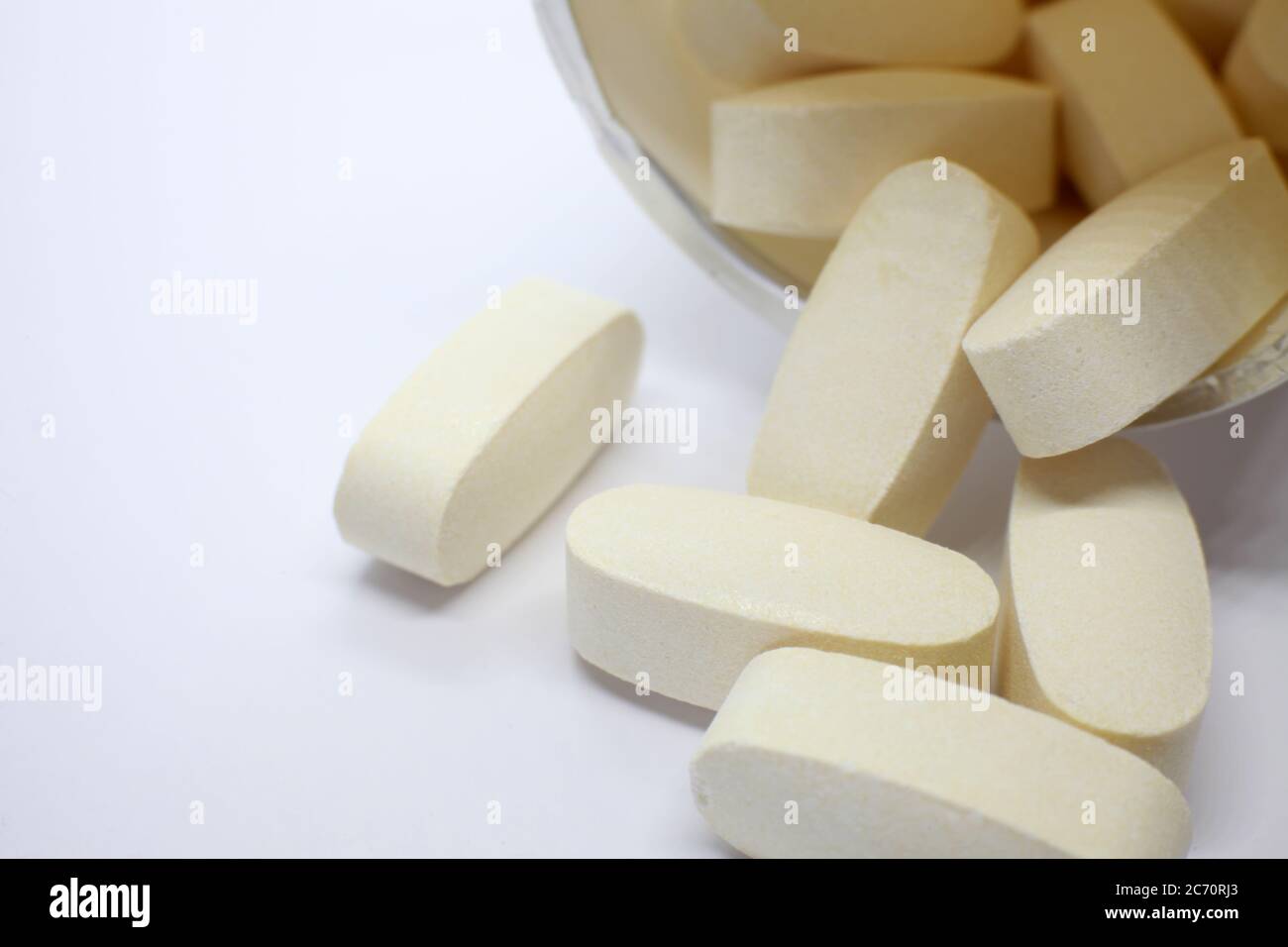 pills spilling from container Stock Photo