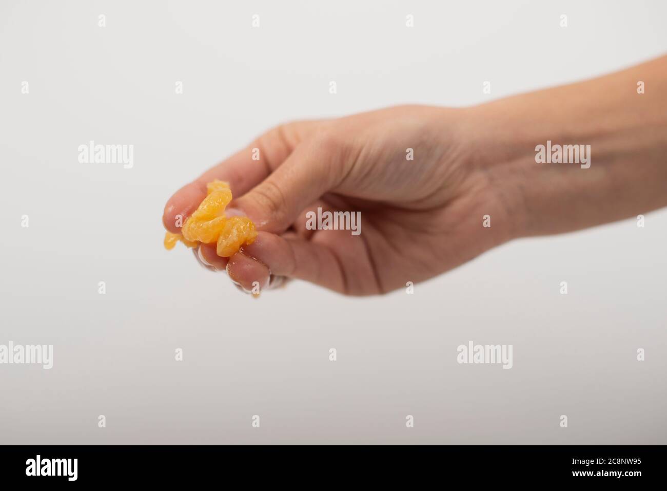 Hand squashing orange Stock Photo