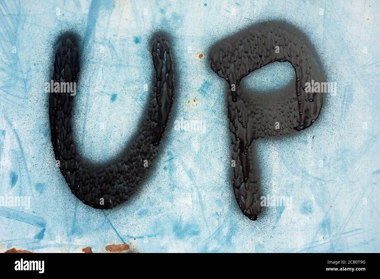 Up sign typography design font with airbrushed black lettering and blue white abstract background. Stock Photo