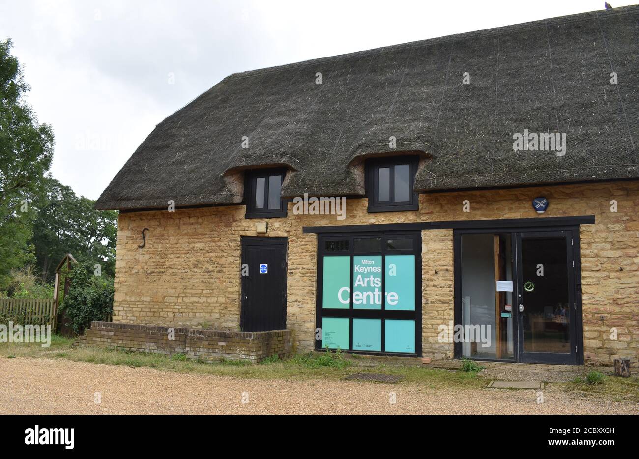 Not what you would expect in Milton Keynes?  Milton Keynes Art Centre is in a rustic building with a thatched roof. Stock Photo