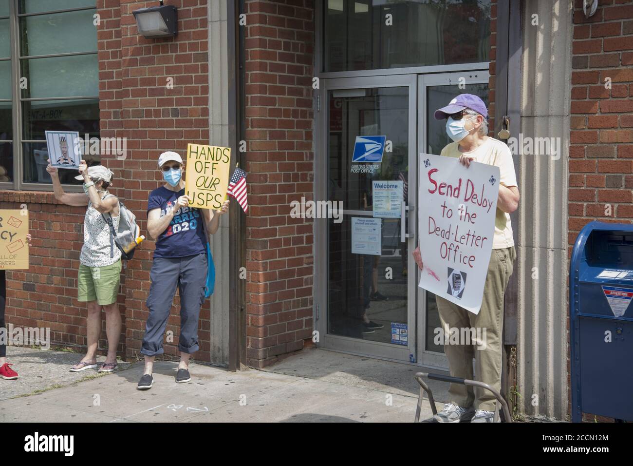 'Save The Post Office Saturday:' Protesters gather in front of nearly 800 Post offices around the country, like this one in Park SLope, Brooklyn, to  support postal workers, demand government funding for the USPS, also demanding the resignation of Postmaster General Louis DeJoy and stop the voter suppression campaign orchestrated by the Trump administration by stopping mail in voting. Stock Photo