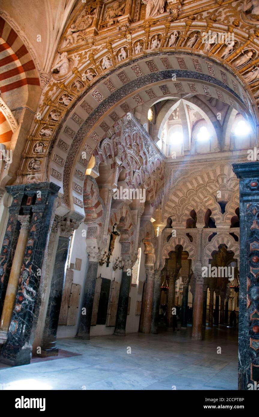 Horseshoe arch through to double tiered pink and white multi-foil arches at the Great Mosque-Cathedral of Cordoba, Spain. Stock Photo