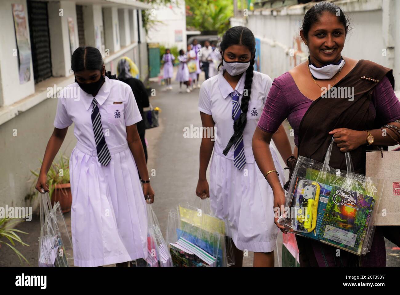 Colombo, Sri Lanka. 2nd Sep, 2020. Students and a teacher carry gifts of stationery provided by the Chinese embassy to Sri Lanka, in Colombo, Sri Lanka, Sept. 2, 2020. Over 700 students from 19 schools in Sri Lankan capital city have received gifts of stationery and panda school bags from the Chinese embassy to Sri Lanka. Credit: Tang Lu/Xinhua/Alamy Live News Stock Photo