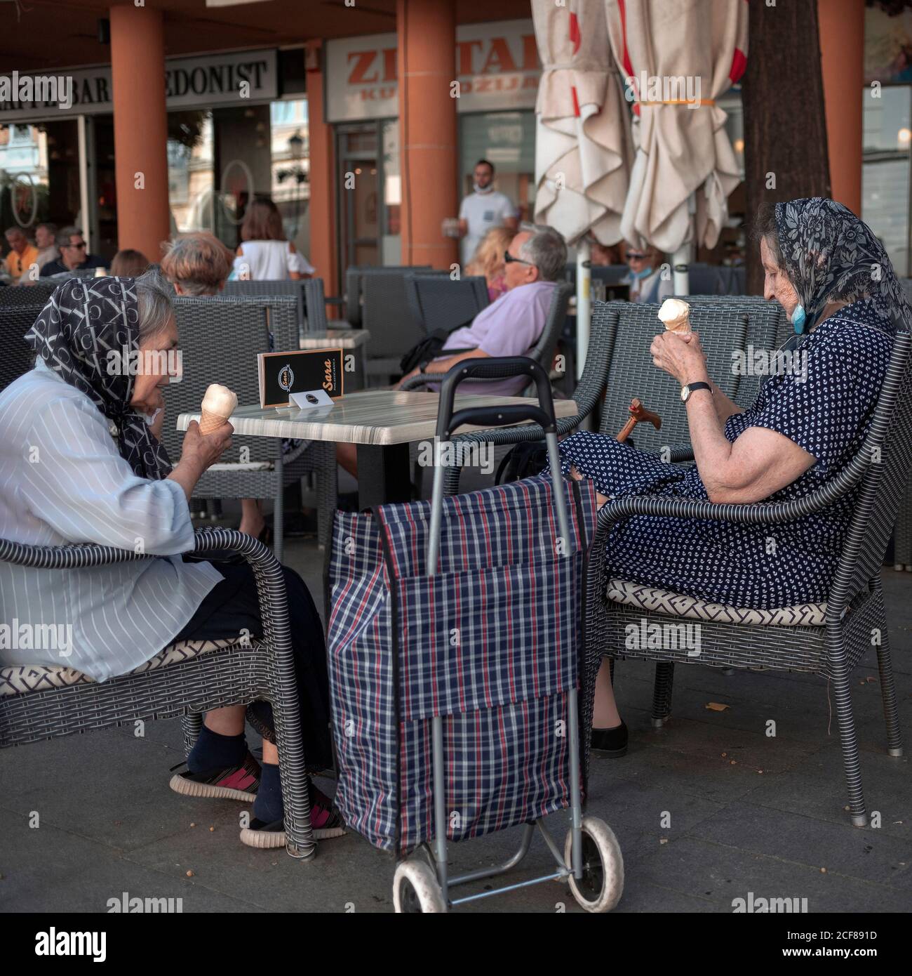 Belgrade, Serbia, Aug 31, 2020: Two women sitting at a café and eating ice cream Stock Photo