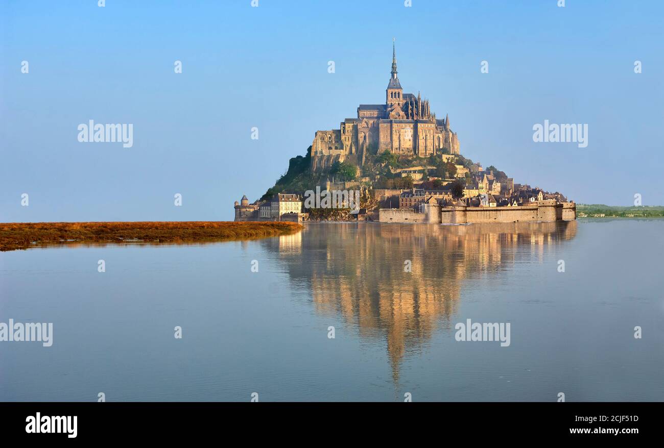 Scenic view of the tidal island  of Mont Saint Michel at high tide surrounded and its medieval abbey of Saint Michel. Normandy France.  The tides vary Stock Photo