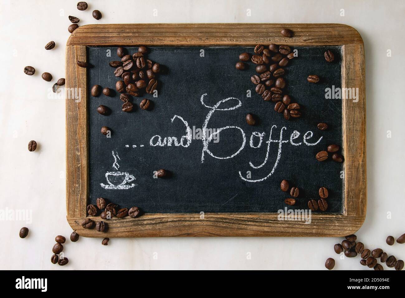 Coffee beans on vintage chalkboard with lettering over white marble ...