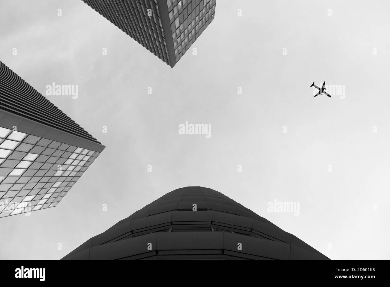 Germany, Duesseldorf, view to plane and facades of high-rise buildings from below Stock Photo