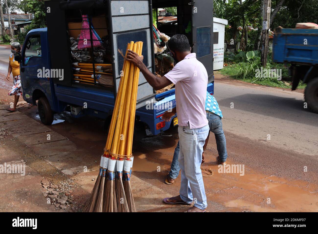 A bundle of handmade brooms which are made by coconut sticks. These are the most famous outdoor cleaning brooms delivering shop by shop. Stock Photo