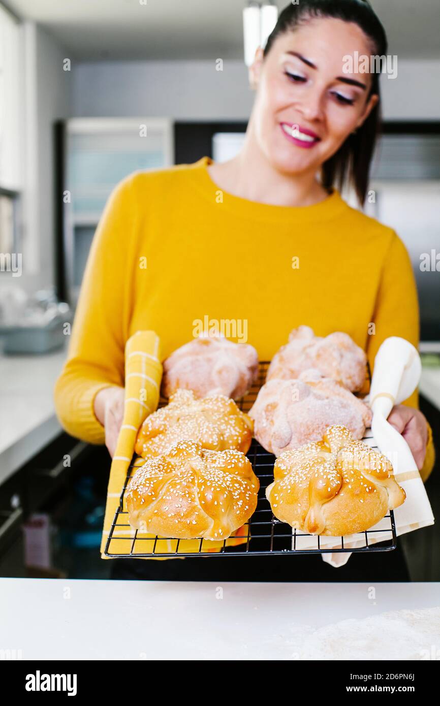 mexican woman cooking Pan de Muerto traditional bread for day of the dead in Mexico Stock Photo