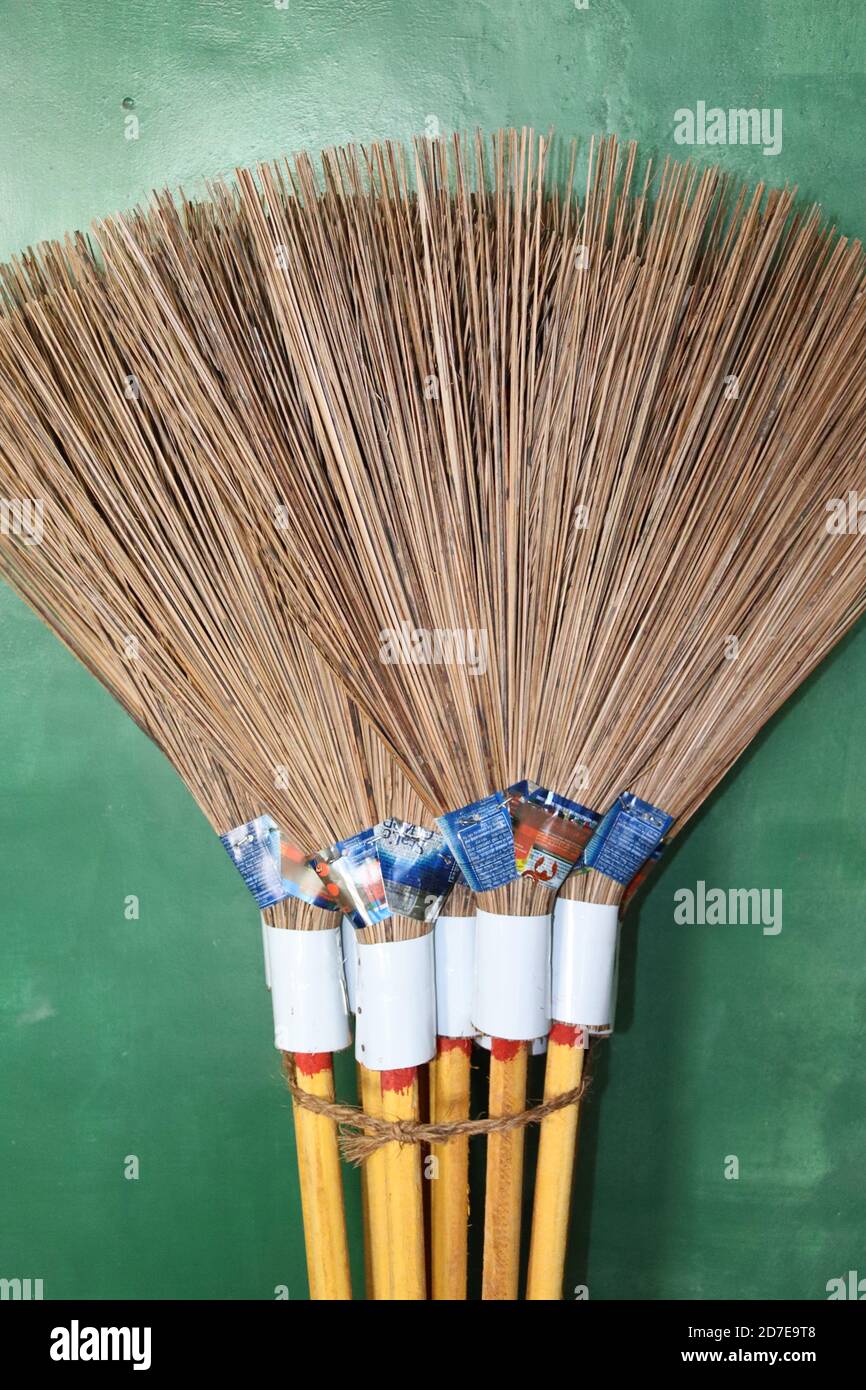 A bundle of handmade brooms, made by coconut sticks. Most famous outdoor cleaning broom in Sri Lanka. This is one destination of coconut tree parts. Stock Photo