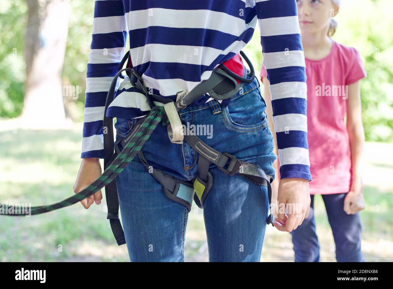 Children prepare for a bungee jump, put on safety belts Stock Photo