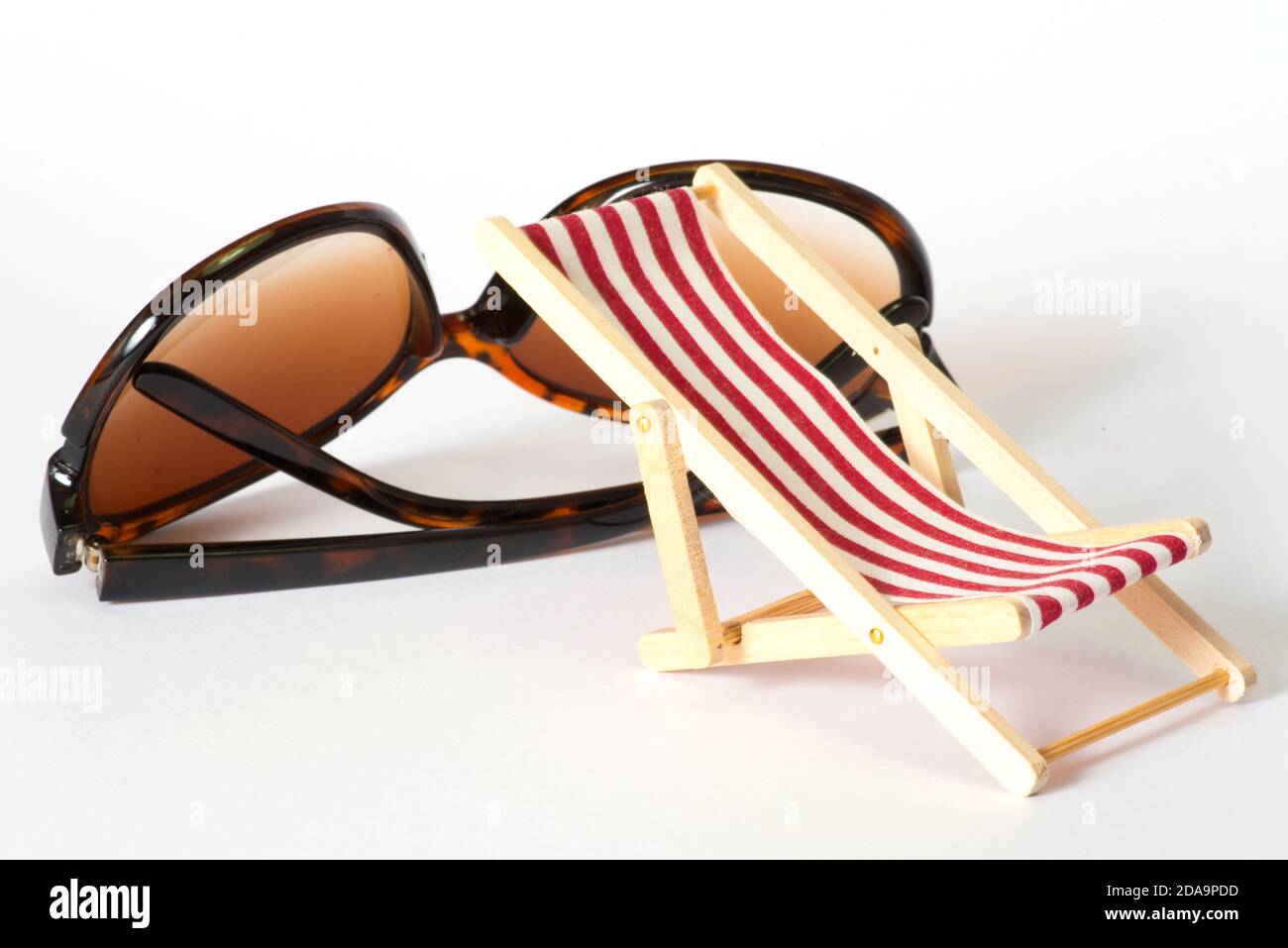 Sunglasses and a deck chair on a vacation Stock Photo