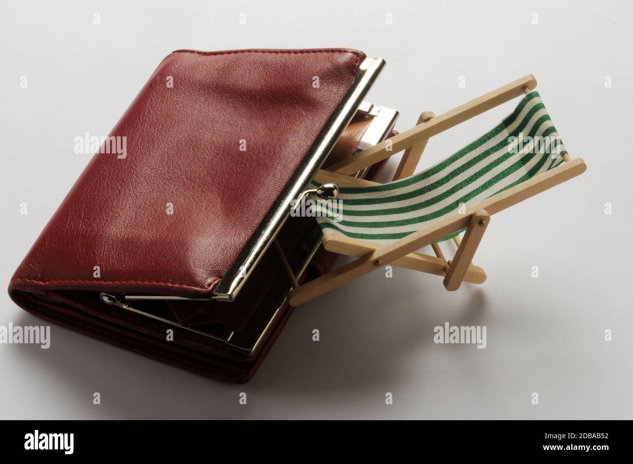 Deck chair with purse on white background Stock Photo