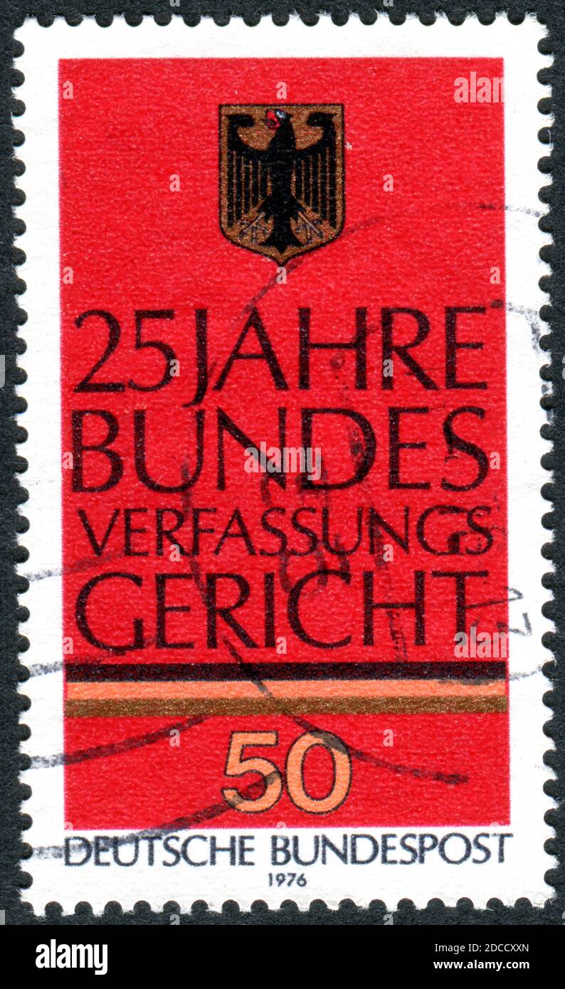 A stamp printed in Germany, dedicated to the 25th Anniv. of Federal Constitutional Court, Karlsruhe, shown of Emblem and Commemorative Inscription Stock Photo