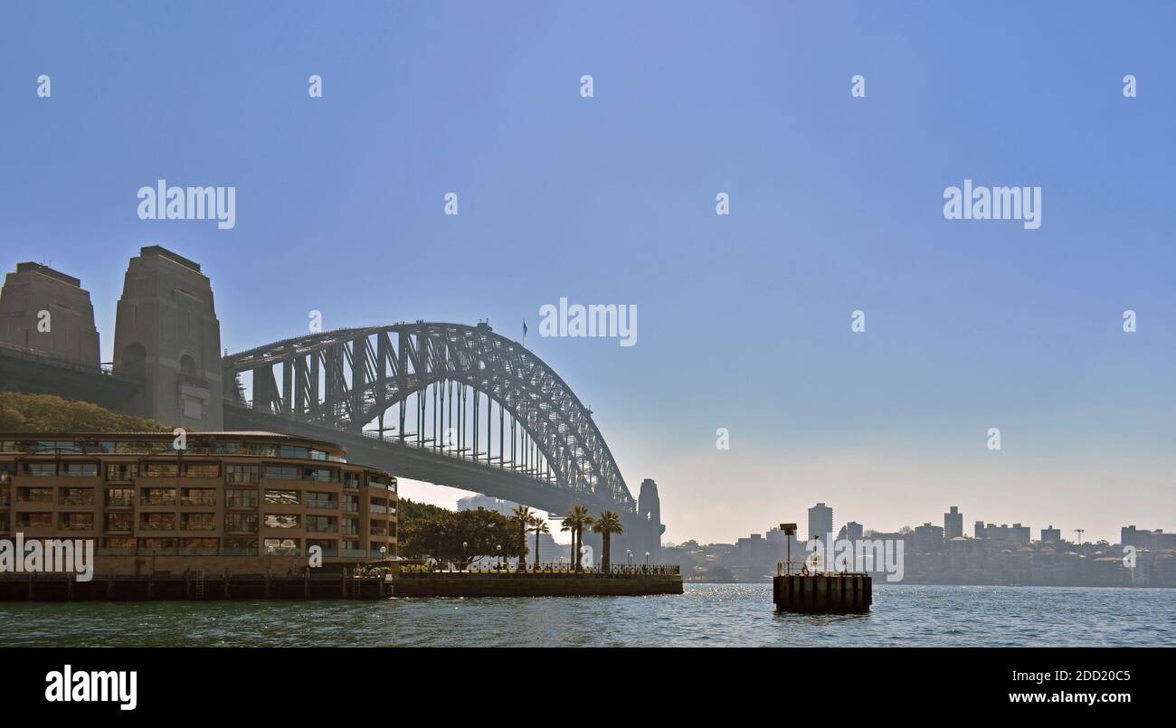 Sydney Harbour Bridge and the Park Hyatt Sydney hotel seen from the water of Circular Quay on a hazy day. Sydney, New South Wales, Australia. Stock Photo