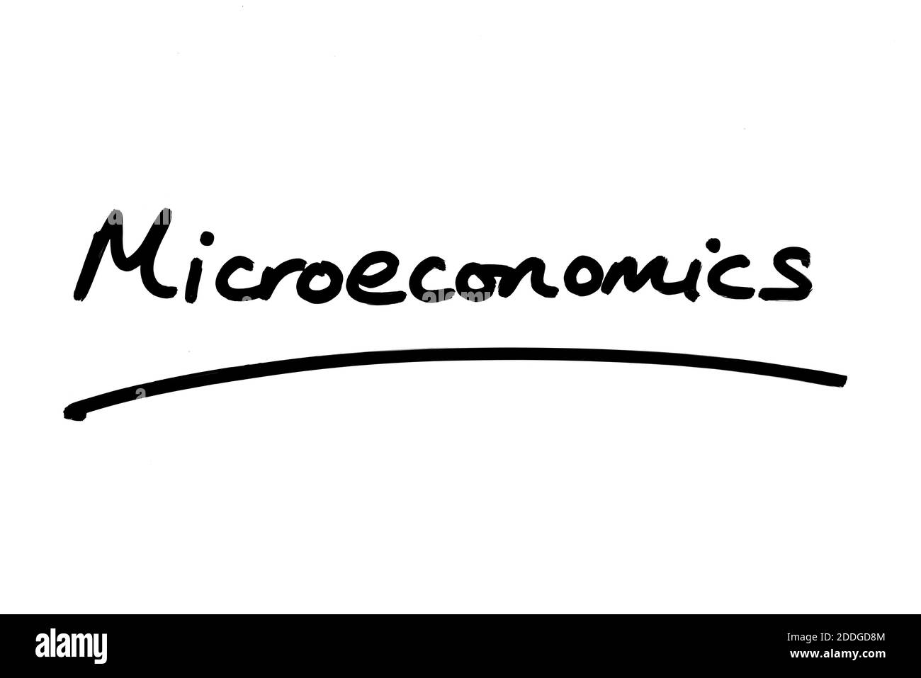 Microeconomics handwritten on a white background. Stock Photo