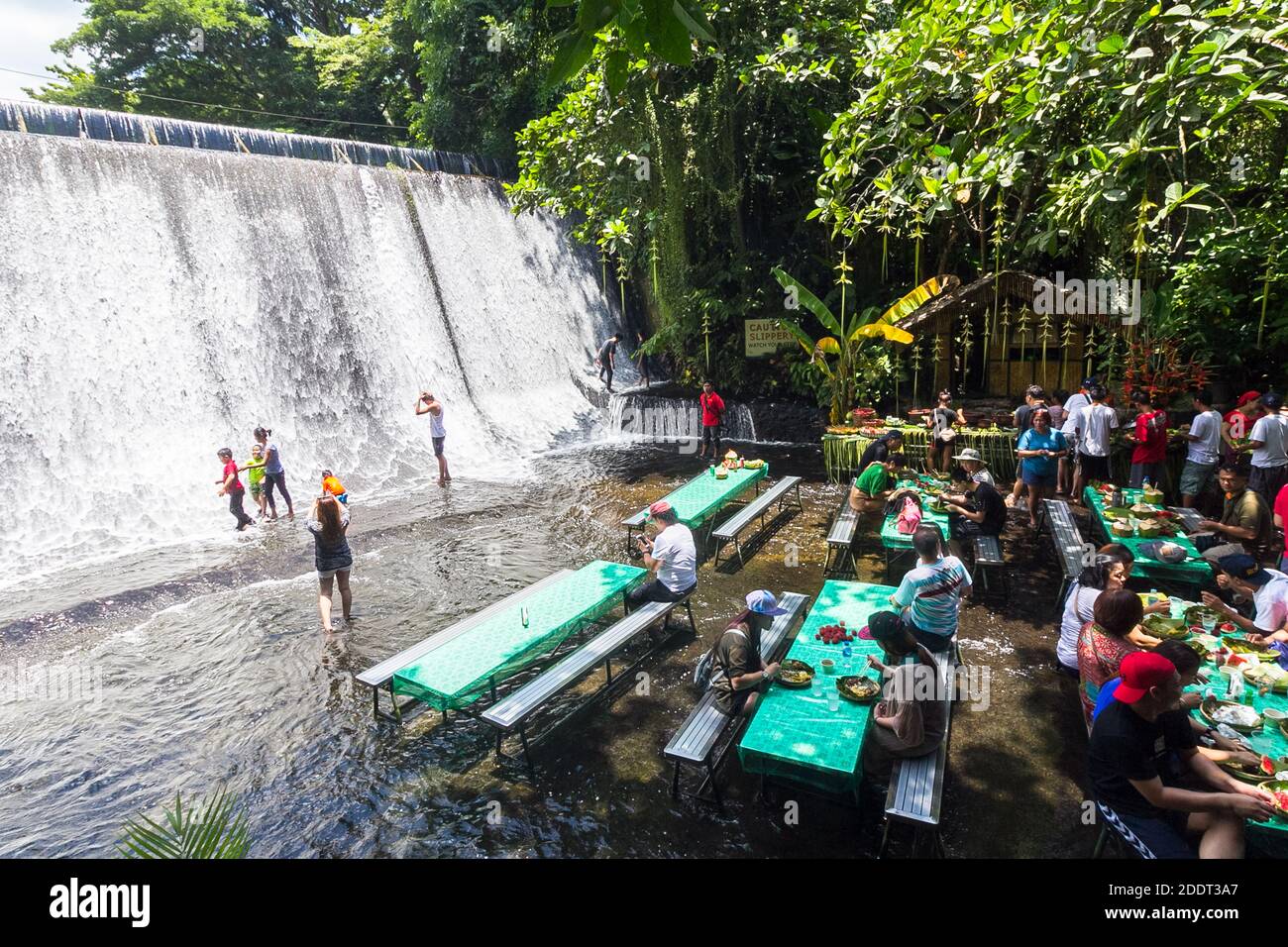 Al fresco dining at the man made waterfall in Villa Escudero, Quezon, Philippines Stock Photo