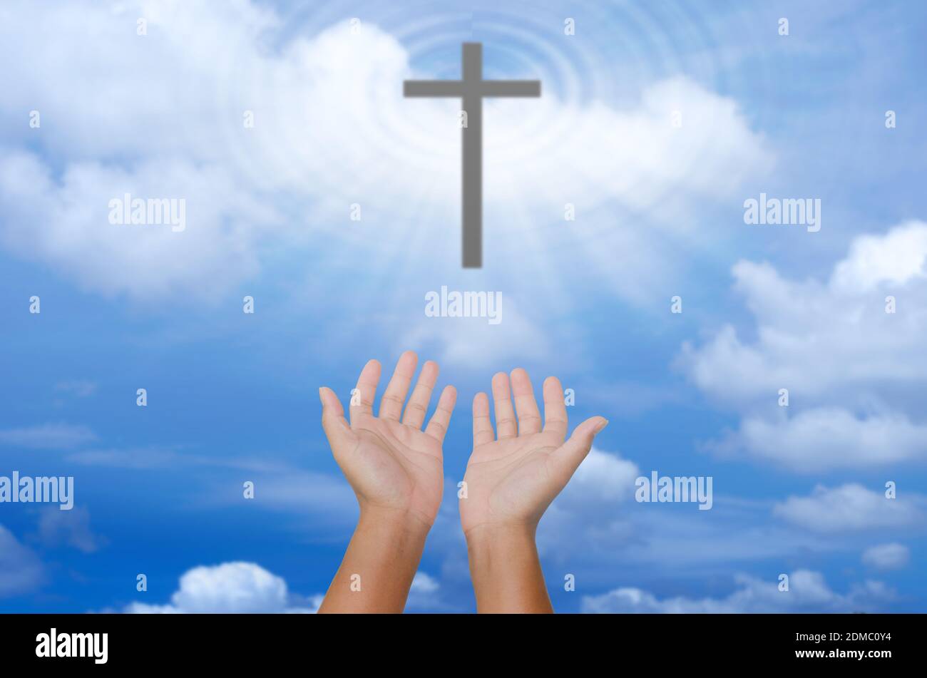 open hands praying the cross on blur sky background Stock Photo - Alamy