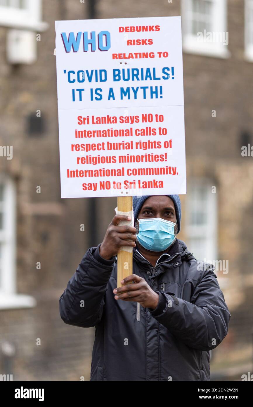 Protester with placard during protest against forced cremation of COVID-19 victims in Sri Lanka, Embassy of Sri Lanka, London, 12 December 2020 Stock Photo