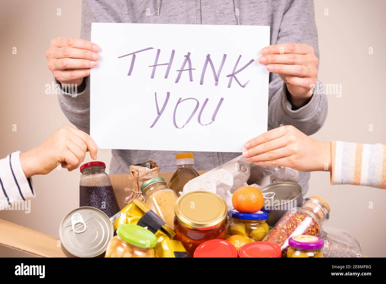 Thank you for donation. Volunteers holding paper sheet with message ...