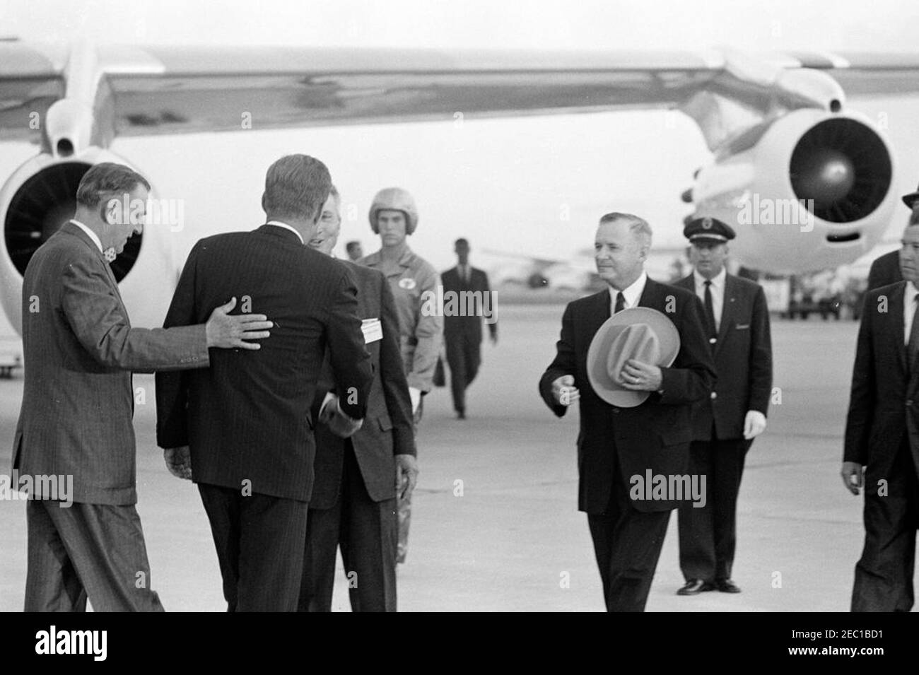 Inspection tour of NASA installations: Houston, Texas, arrival, 6:15PM. President John F. Kennedy (back to camera) greets Mayor of Houston, Texas, Lewis Cutrer, upon arrival at Houston International Airport, Houston, Texas. Left to right (in foreground): Representative Albert Thomas (Texas); President Kennedy; Mayor Cutrer (partially hidden, shaking hands with the President); Governor of Texas, Price Daniel (holding hat); Harris County Judge, Bill Elliott (mostly out of frame). President Kennedy traveled to Houston as part of a two-day inspection tour of National Aeronautics and Space Administ Stock Photo