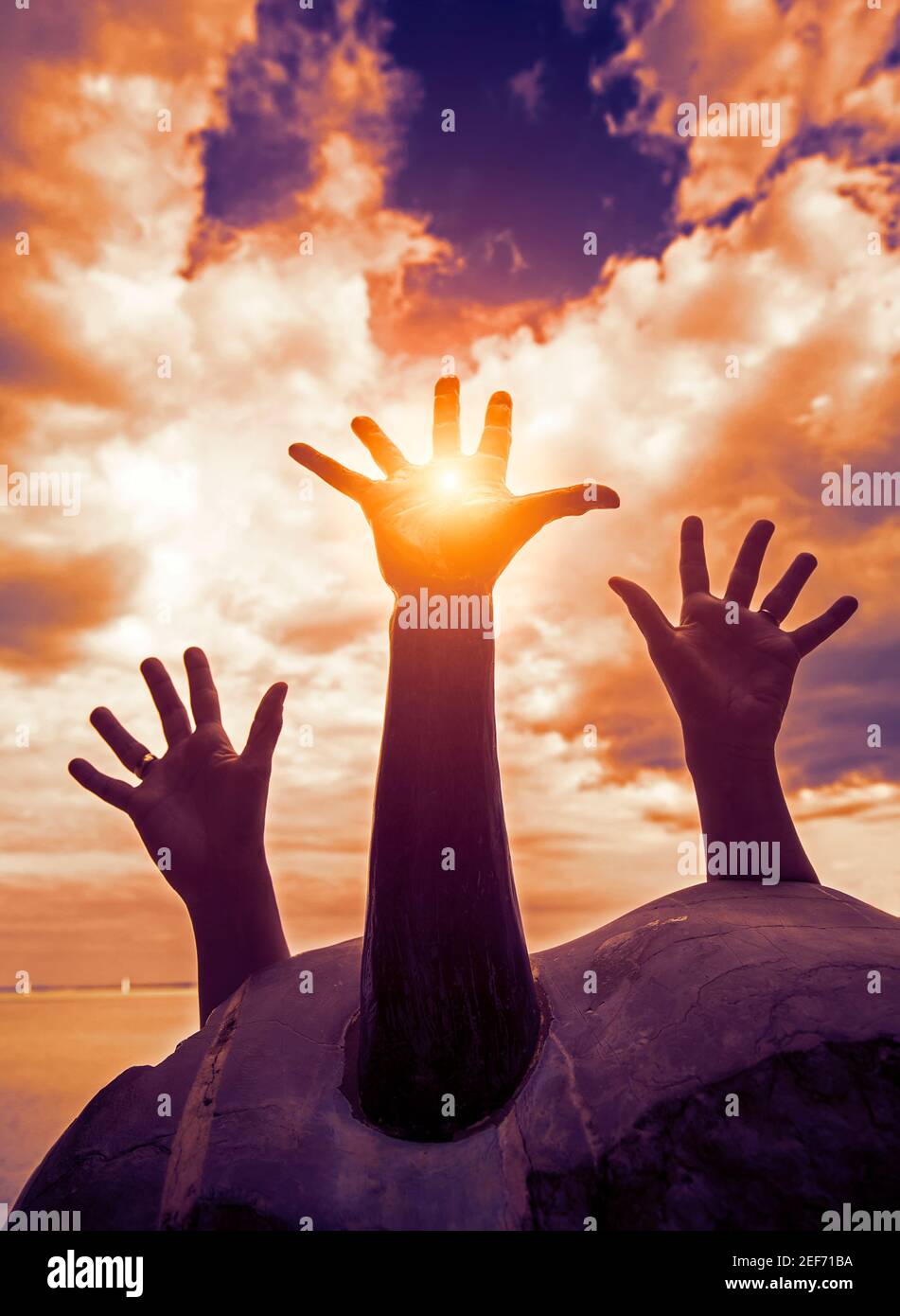 Hands asking help against cloudscape Stock Photo