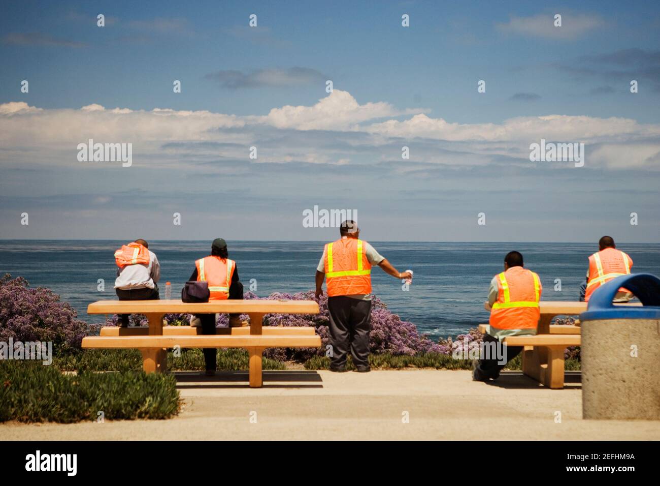 Rear view of workers looking at the ocean view Stock Photo