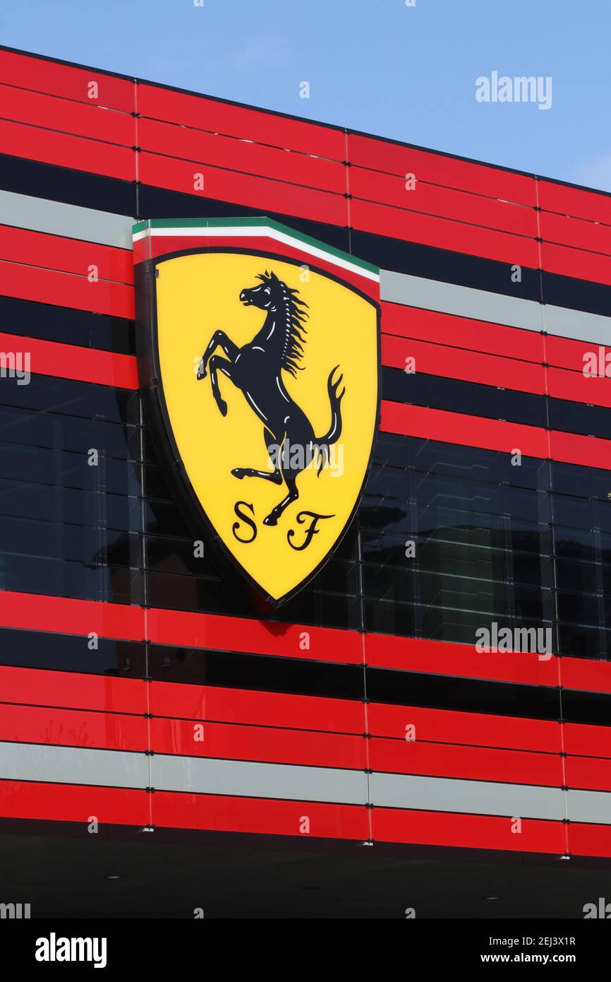 Maranello, Modena, Italy, February 2021 - Entrance of the modern Ferrari Automobiles factory with the Scuderia Ferrari F1 logo in the foregroun Stock Photo