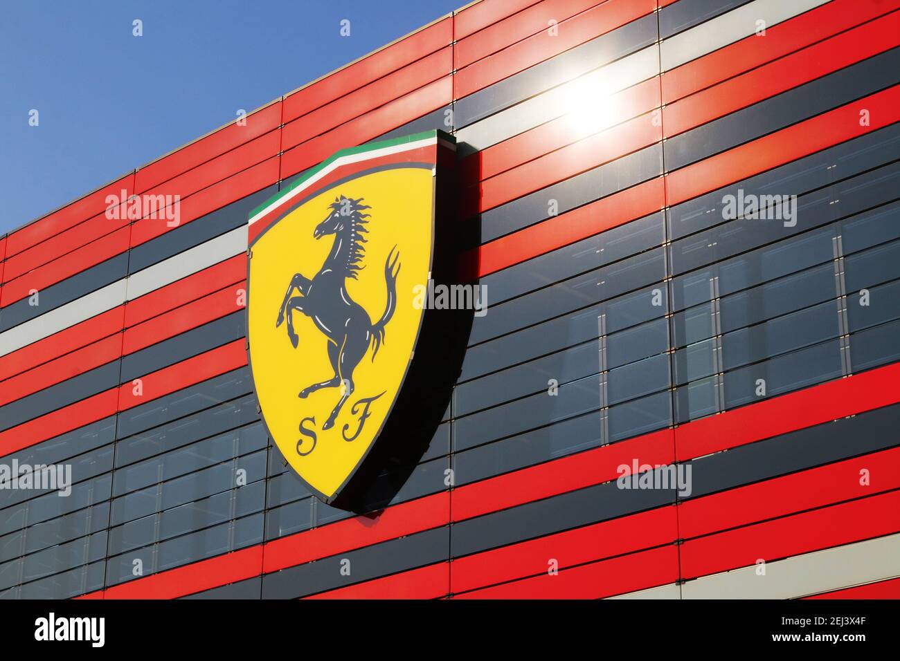 Maranello, Modena, Italy, February 2021 - Entrance of the modern Ferrari Automobiles factory with the Scuderia Ferrari F1 logo in the foregroun Stock Photo