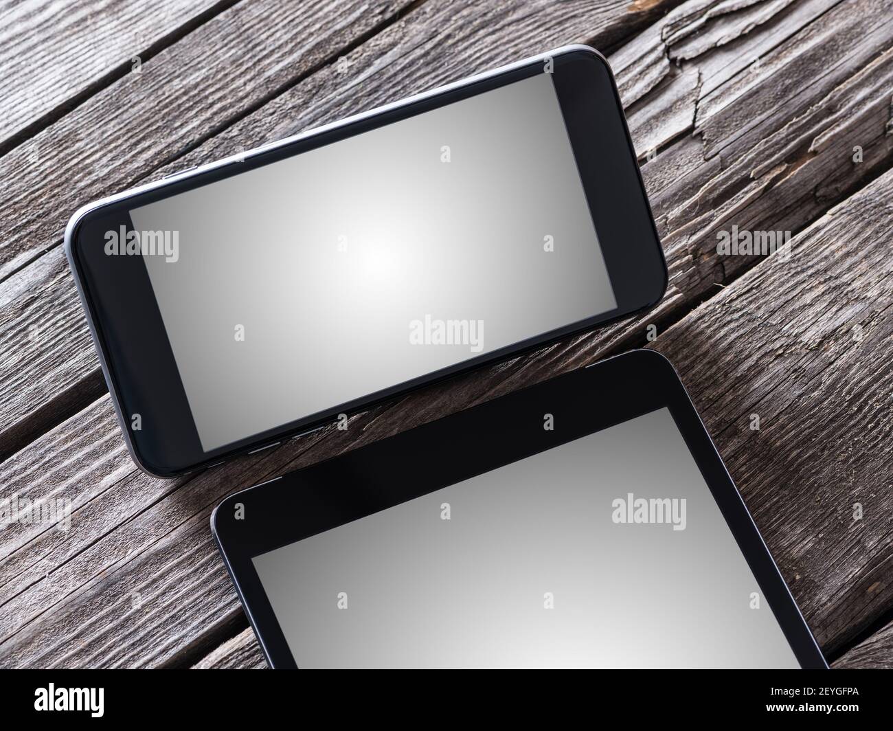 Smart phone and tablet pc on a desktop. Clipping paths included. Stock Photo