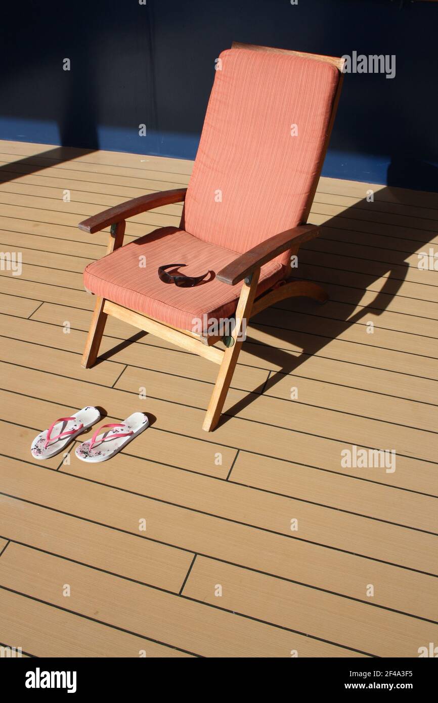 Deck Chair with Filp Flops on deck Stock Photo